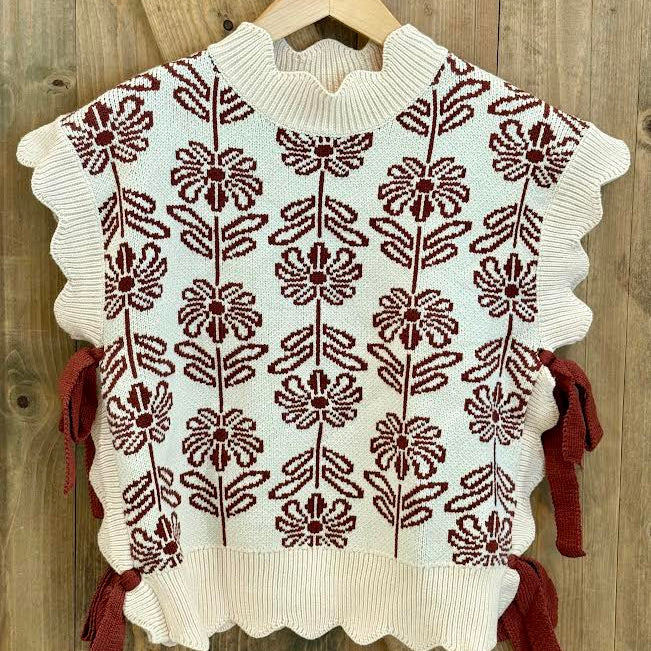White sweater with brown floral pattern and bows on the side