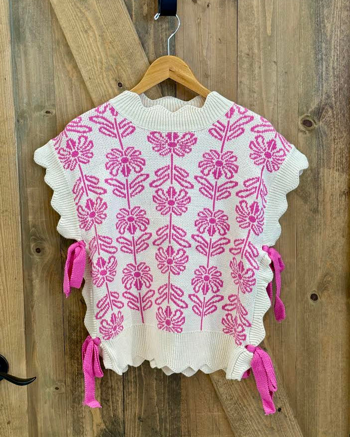 White sweater with pink floral pattern and bows on the side
