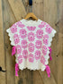 White sweater with pink floral pattern and bows on the side
