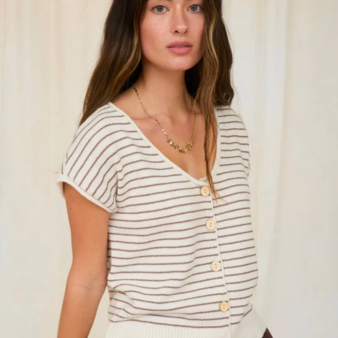 Elevate your layering game with this versatile scoop neck cardigan, designed for effortless sophistication. The raw edge detailing adds contemporary edge while the short sleeves offer breathable comfort for transitional seasons. 